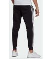 Pantalones técnicos running - Adidas Pantalones Essentials Fleece Fitted 3-Stripes negro Textil Running